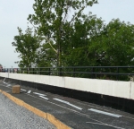 Bridge rail with black safety powder coating.